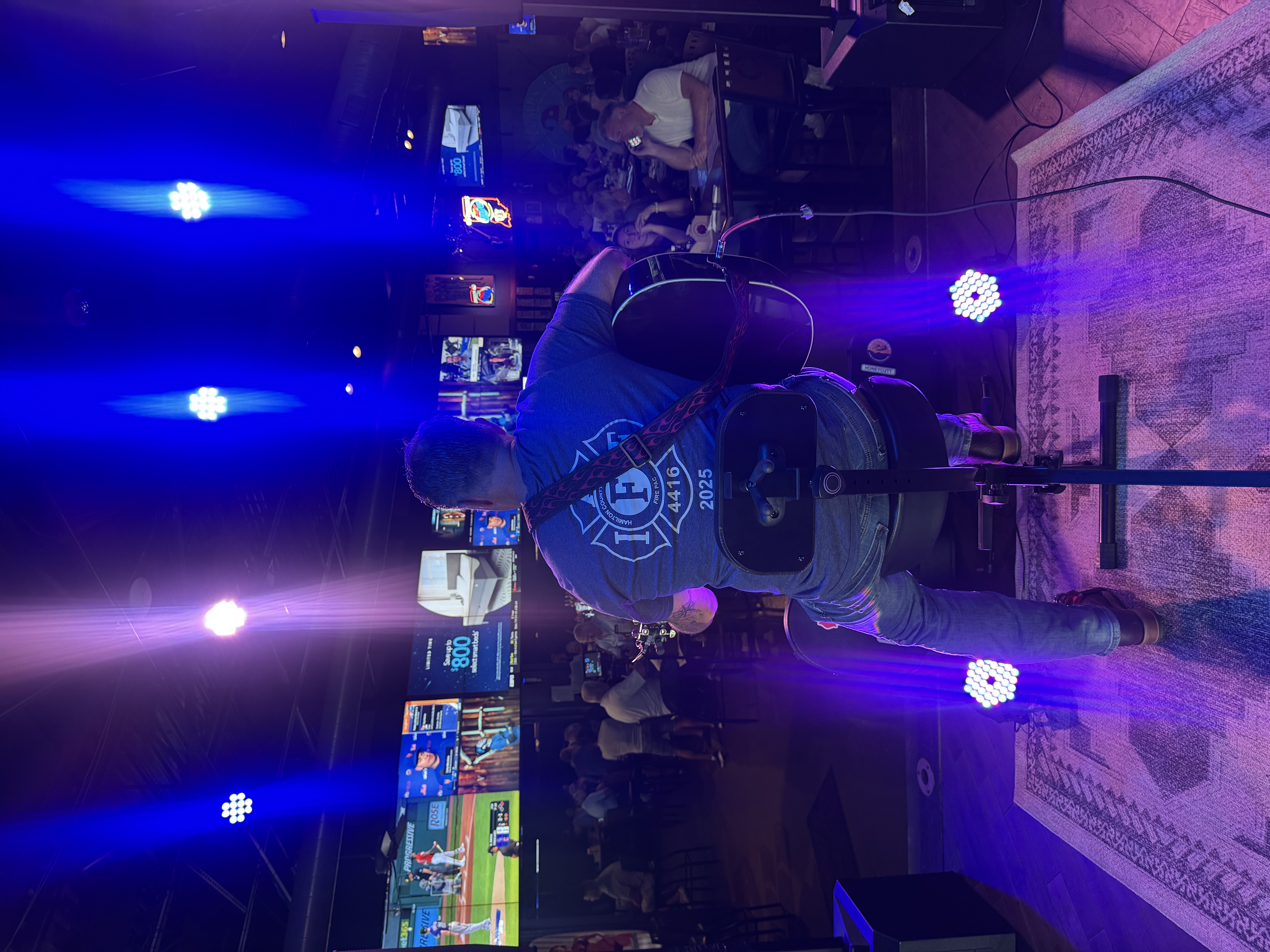 Steve playing at sunset on a waterfront patio